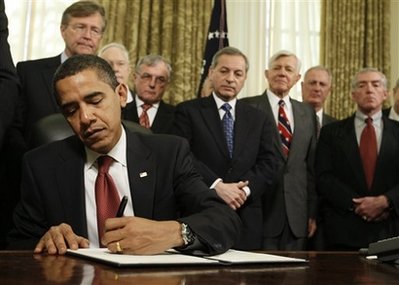 President Barack Obama signs a series of executive orders, including one closing of the prison at Guantanamo Bay, Thursday, Jan. 22, 2009, in the Oval Office of the White House in Washington. (AP Photo/Charles Dharapak)