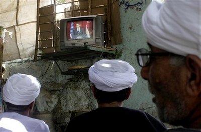 Egyptian villagers watch a live broadcast of a speech by U.S. President Barack Obama is seen on screen at a coffee shop in Qena, south Cairo, Egypt, Thursday, June 4, 2009. Obama was calling for a new beginning between the United States and Muslims, during his speech delivered at Cairo University in Egypt. (AP Photo)