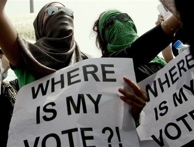 Iranian supporters of defeated presidential candidate Mir Hossein Mousavi hold signs during a demonstration outside the Iranian consulate in Dubai on June 15. Mahmoud Ahmadinejad has again slammed US President Barack Obama for "interfering" in Iran, as debate over the Iranian president's disputed re-election continued. (AFP/File/Marwan Naamani)