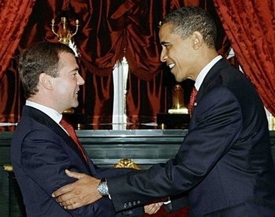 US President Barack Obama (R) shakes hands with Russian President Dmitry Medvedev (L) at the Kremlin in Moscow. Obama later met Russia's powerful Prime Minister Vladimir Putin, a man who he described in the run-up to the summit as having "one foot" in the past of the Cold War. (AFP/RIA/Vladimir Rodionov)